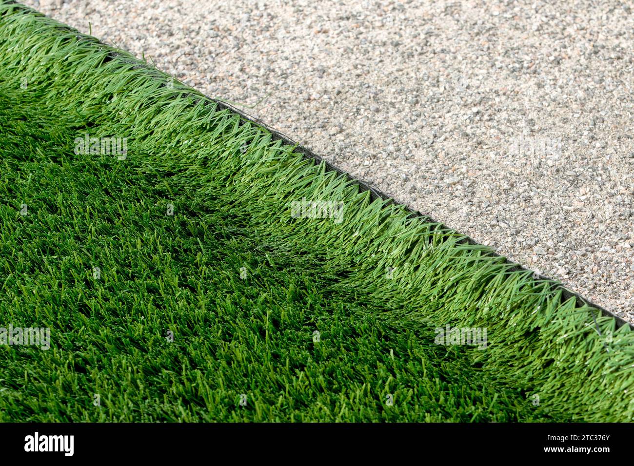 Closeup installation of football field with artificial turf with grass