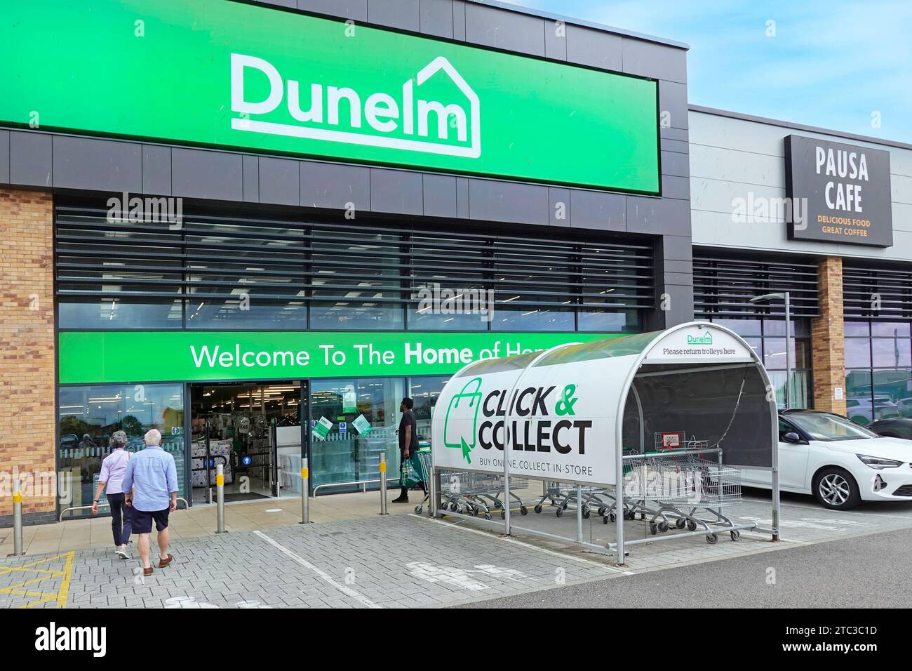 Click & collect sign on shopping trolley shed Dunelm brand welcome store logo home of a Soft furnishing business customers entering Essex England UK Stock Photo