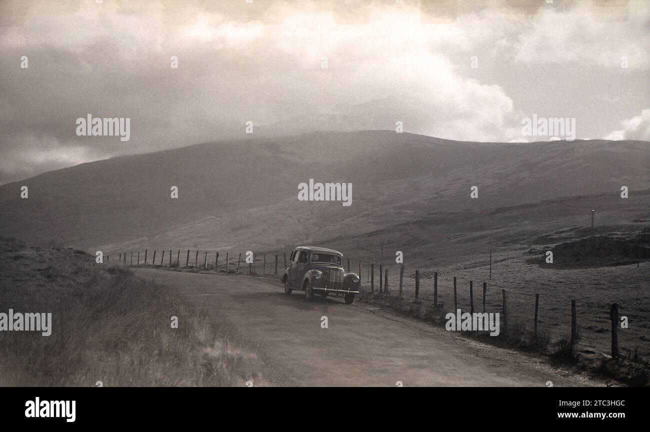 1950s, historical, car of the era, (KRK 362) on country road, mist over the Shropshire Hills