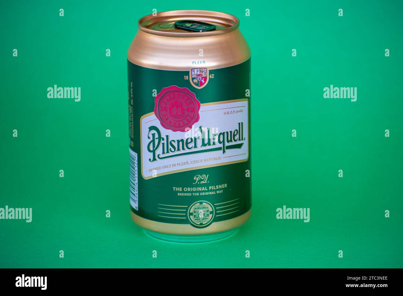 MALAGA, SPAIN - NOVEMBER 17, 2023: Bottle of Pilsner Urquell beer on green background in Malaga, Spain on November 17, 2023 Stock Photo