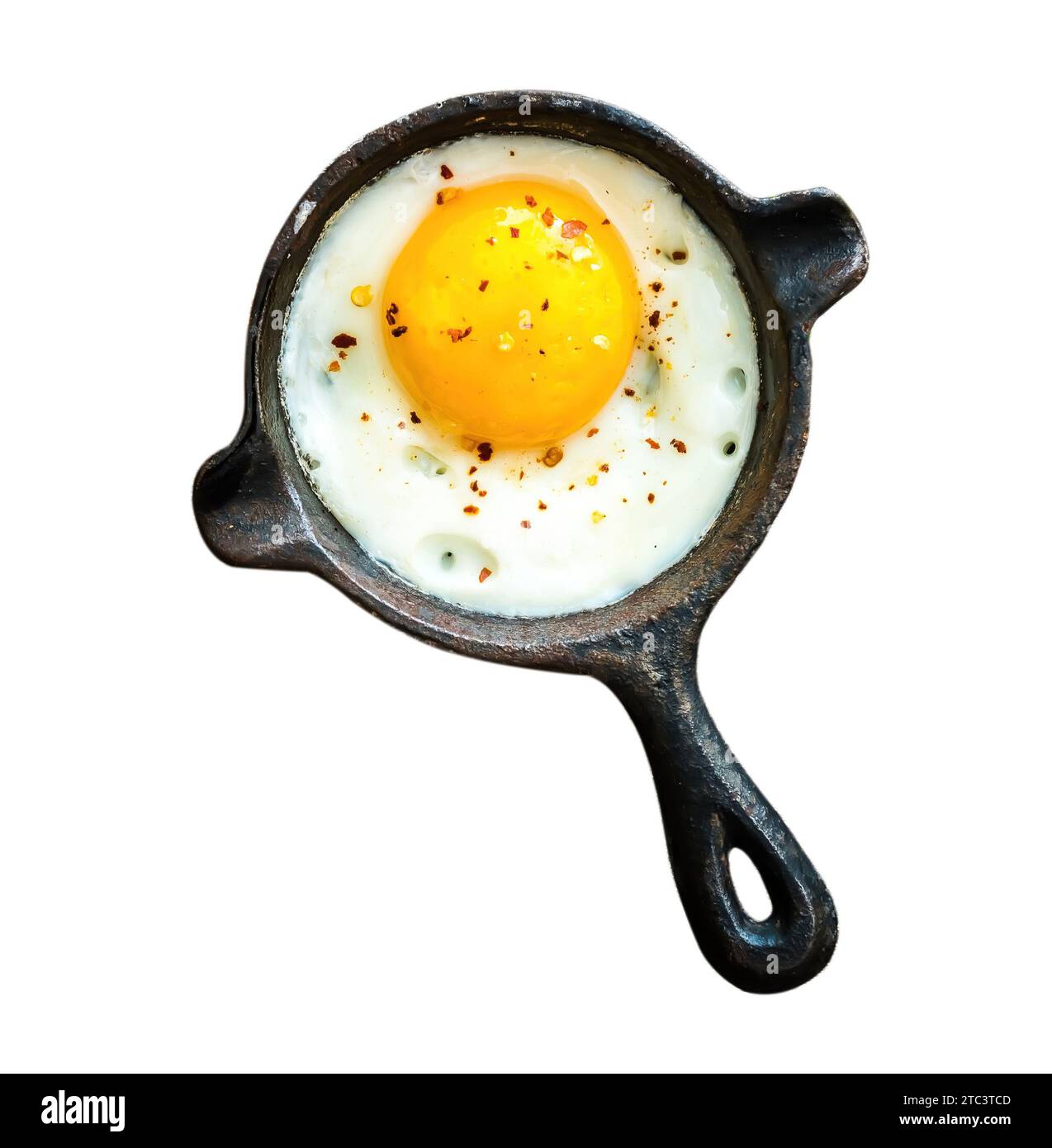 Breakfast fried egg on small black frying pan isolted on white background Stock Photo