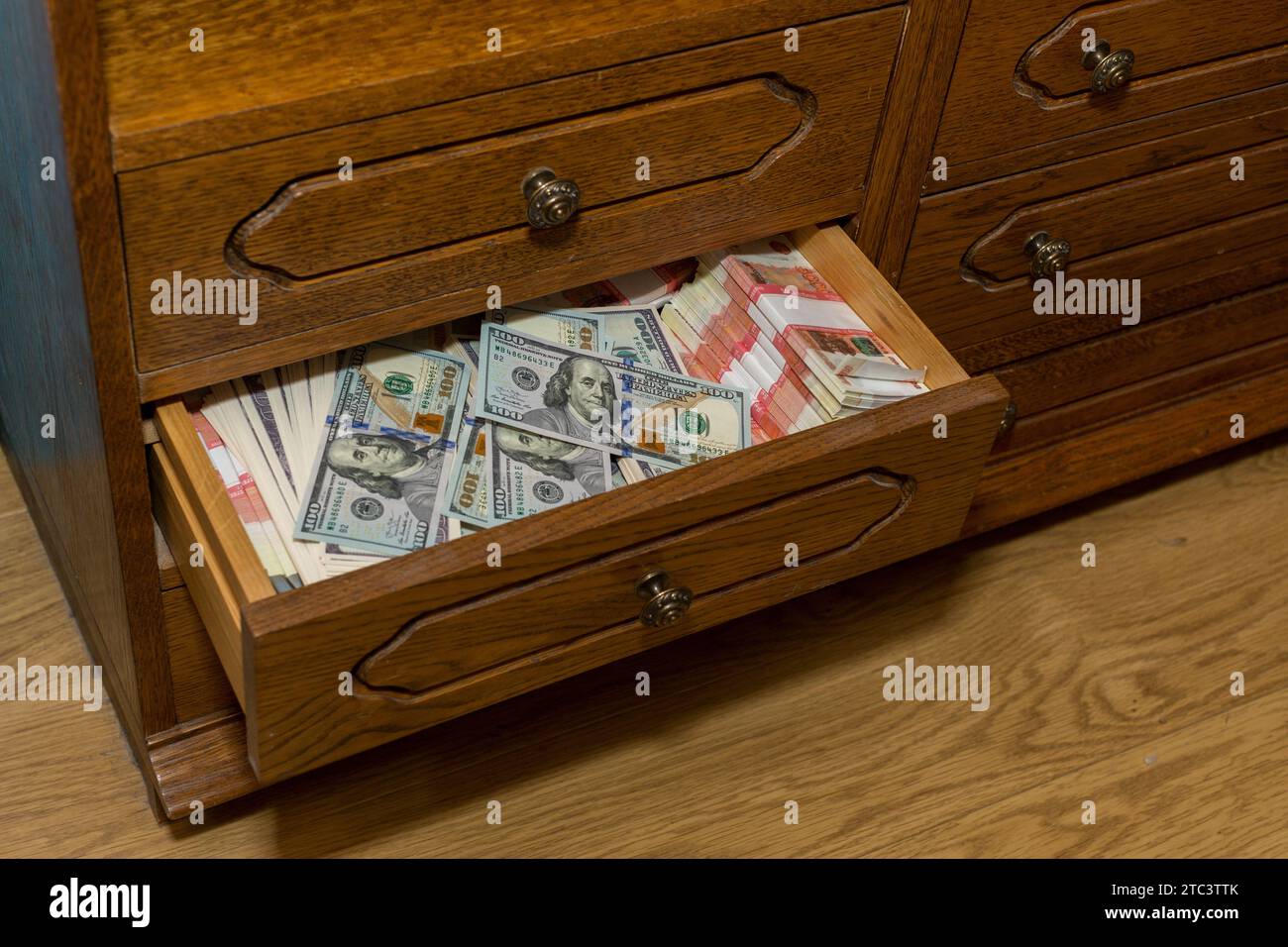 Savings in dollars and in Russian rubles of five thousand each, stored in an old closet. A large amount of money in cash. Stock Photo