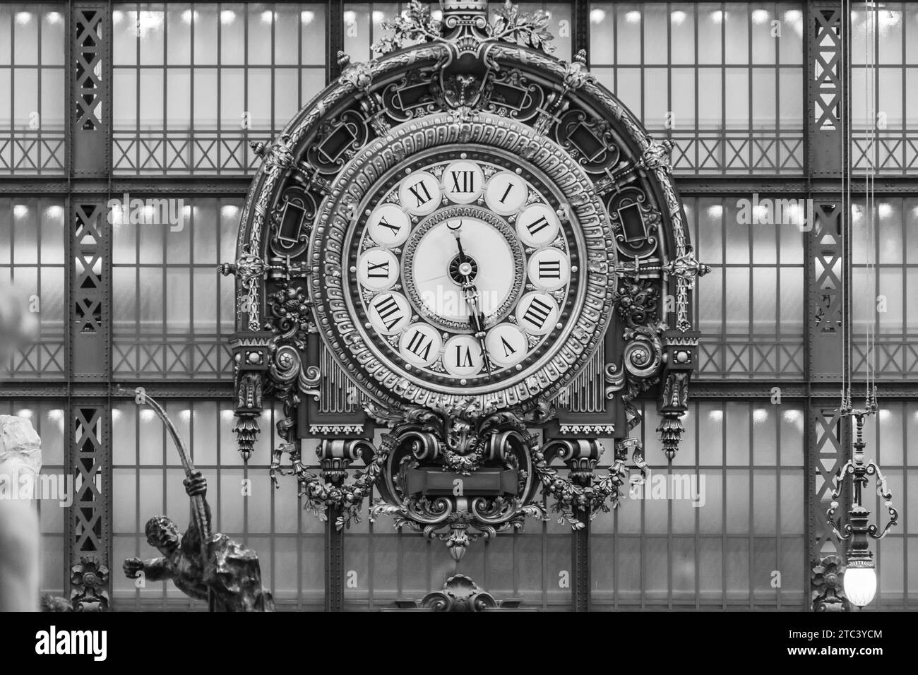 D’Orsay Museum, Paris, France. Golden wooden clock from the 19th century. Interior of the Musée d'Orsay. Black and white image. Stock Photo