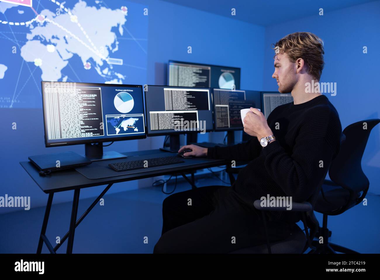 Back View in the Cyber Security Control Center Operator Working. Multiple Screens Showing