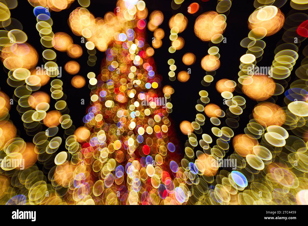 Christmas and Happy new year blurred bokeh. Authentic shot of colorful light on outdoor christmas tree with bokeh. Beautiful christmas bokeh backgroun Stock Photo