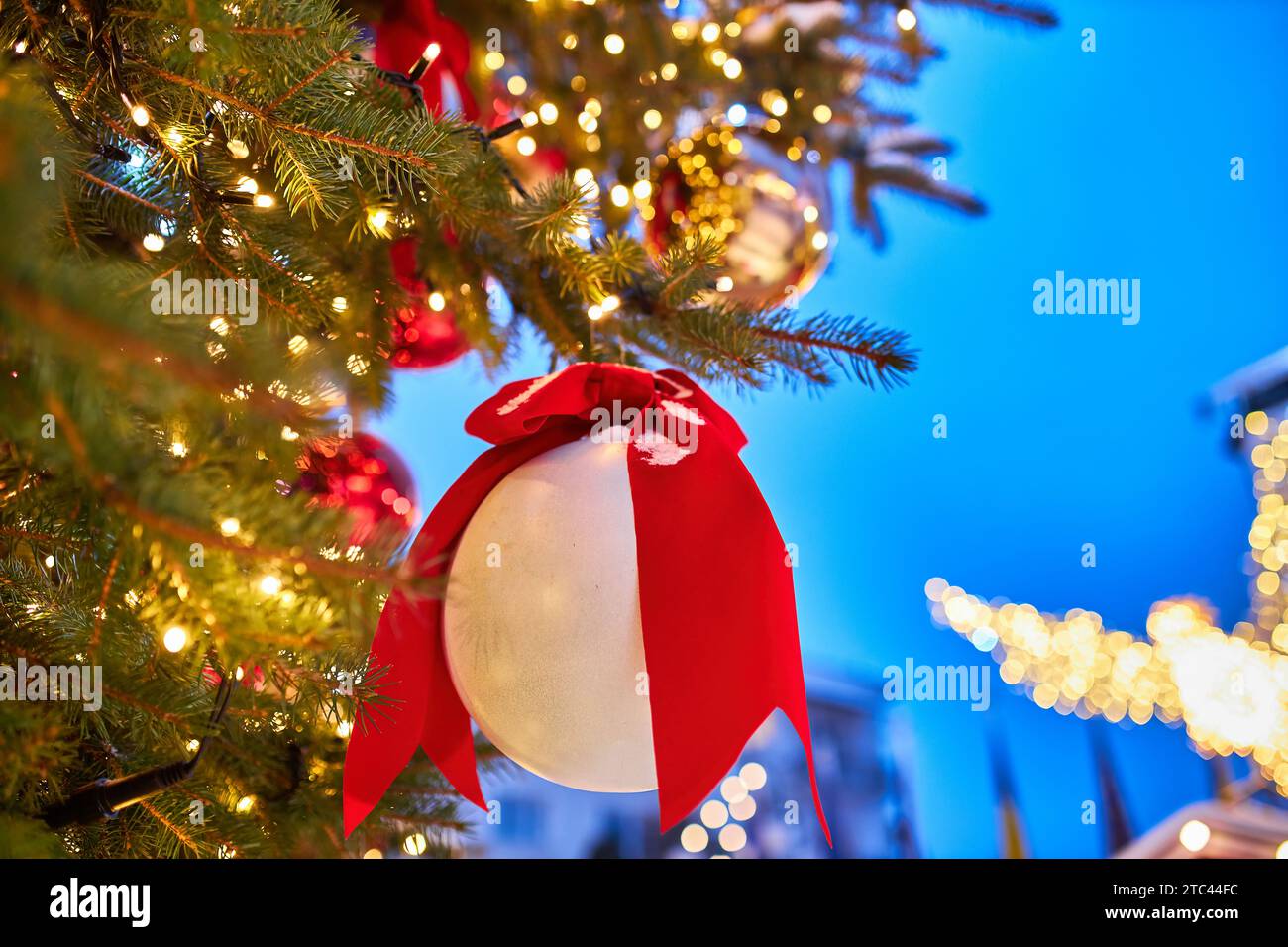 Christmas tree with red balloons on city street at night Stock Photo ...