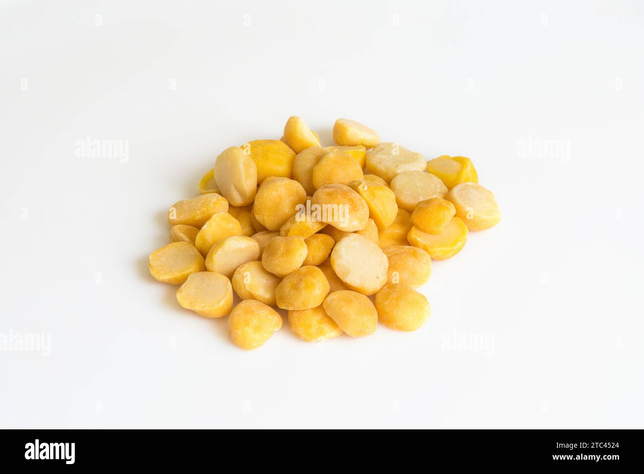 Heap of yellow split chickpeas on white background Stock Photo