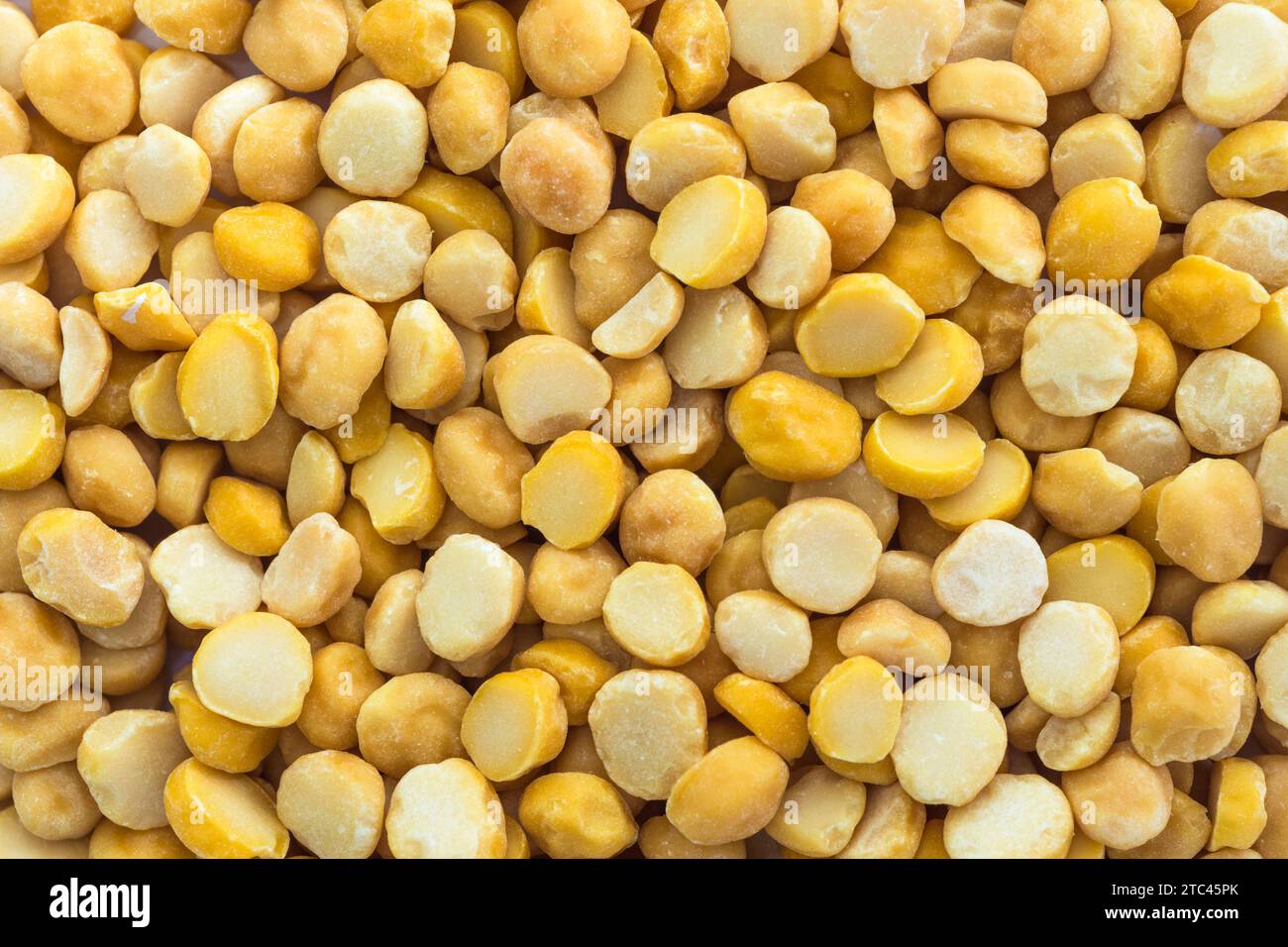 Close-up detail and texture of yellow split chickpeas, top view Stock Photo