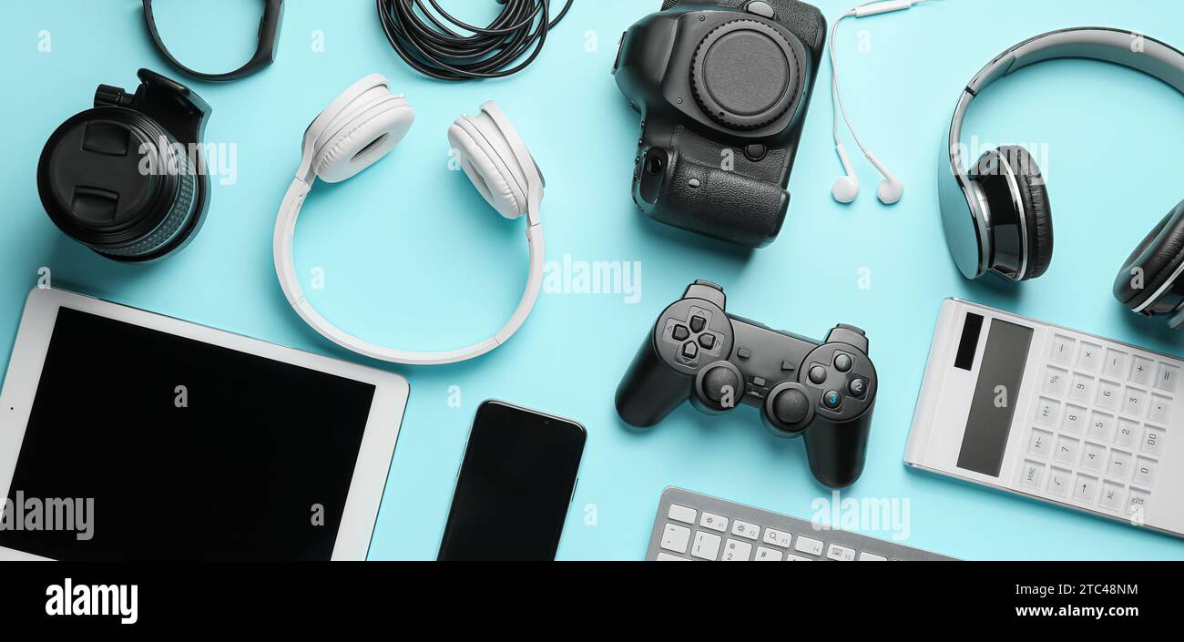 Different modern devices and gadgets on light blue background Stock ...