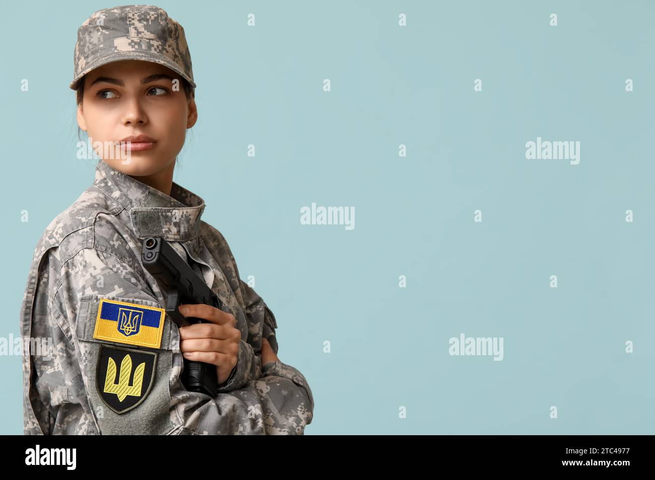 Female soldier in uniform with Ukrainian flag patch on sleeve and ...