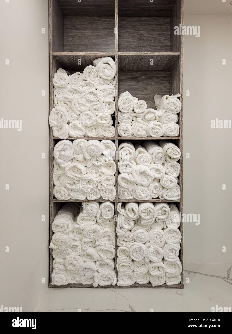 Close up photo of rolled fluffy clean towels at a luxury gym shower or