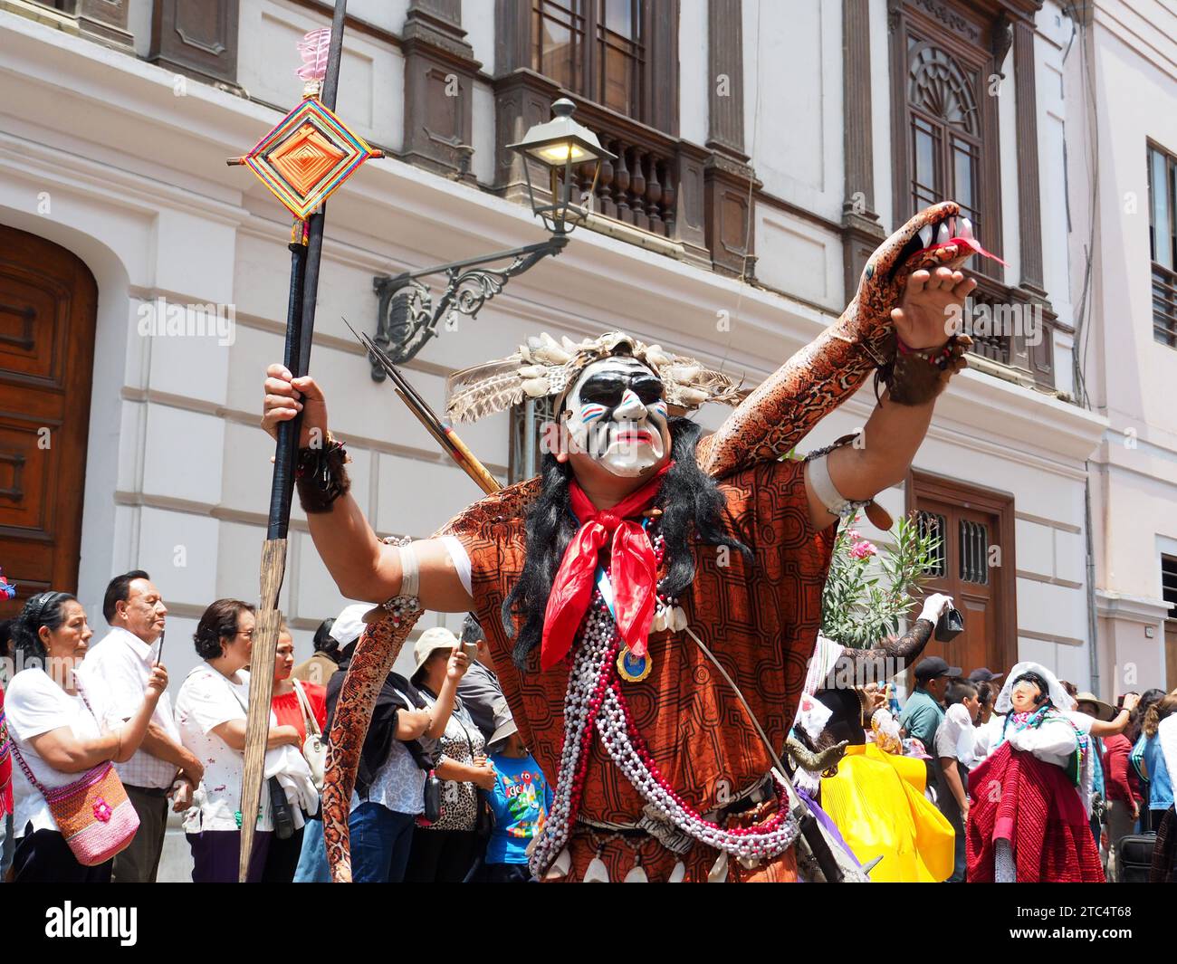 Man with mask and amazon spear from an indigenous Peruvian folk dance group performing through the streets of the historic center of Lima as part of the Municipality of Lima program to disseminate the Andean cultural heritage. Stock Photo