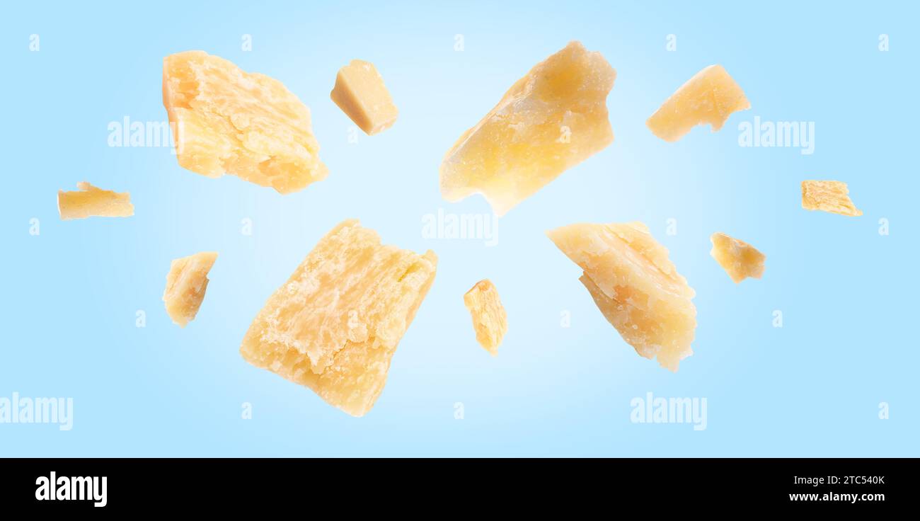 Parmesan cheese in air on light blue background, banner design Stock Photo