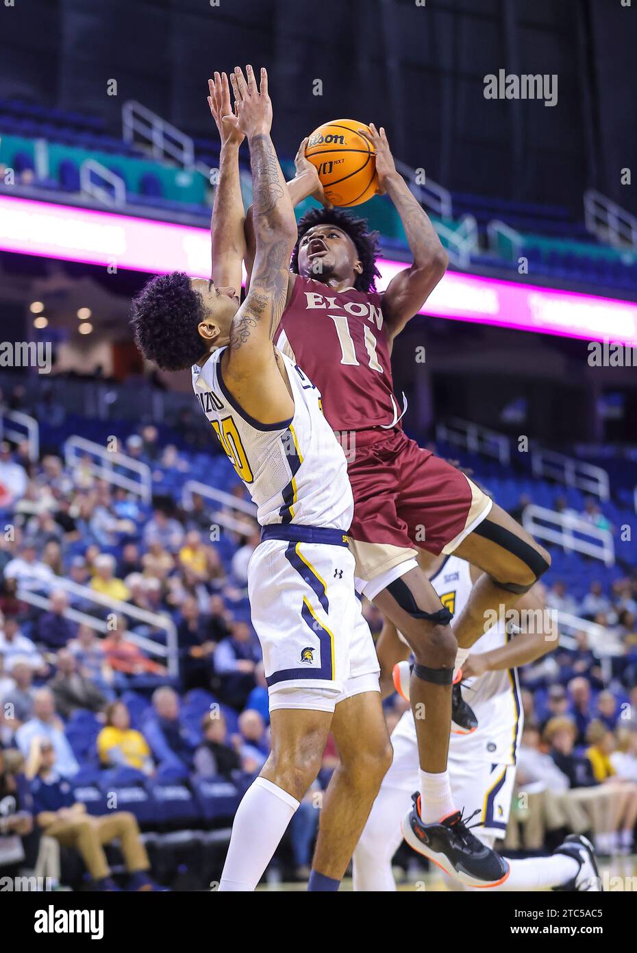 December 10, 2023 Elon University sophomore TK Simpkins (11) goes up