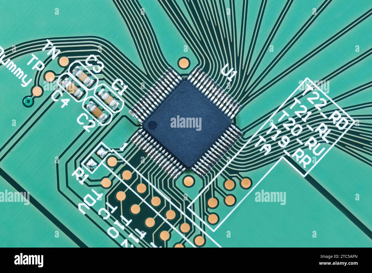 Microprocessor on a green printed circuit board close-up, top view. Macro photography Stock Photo