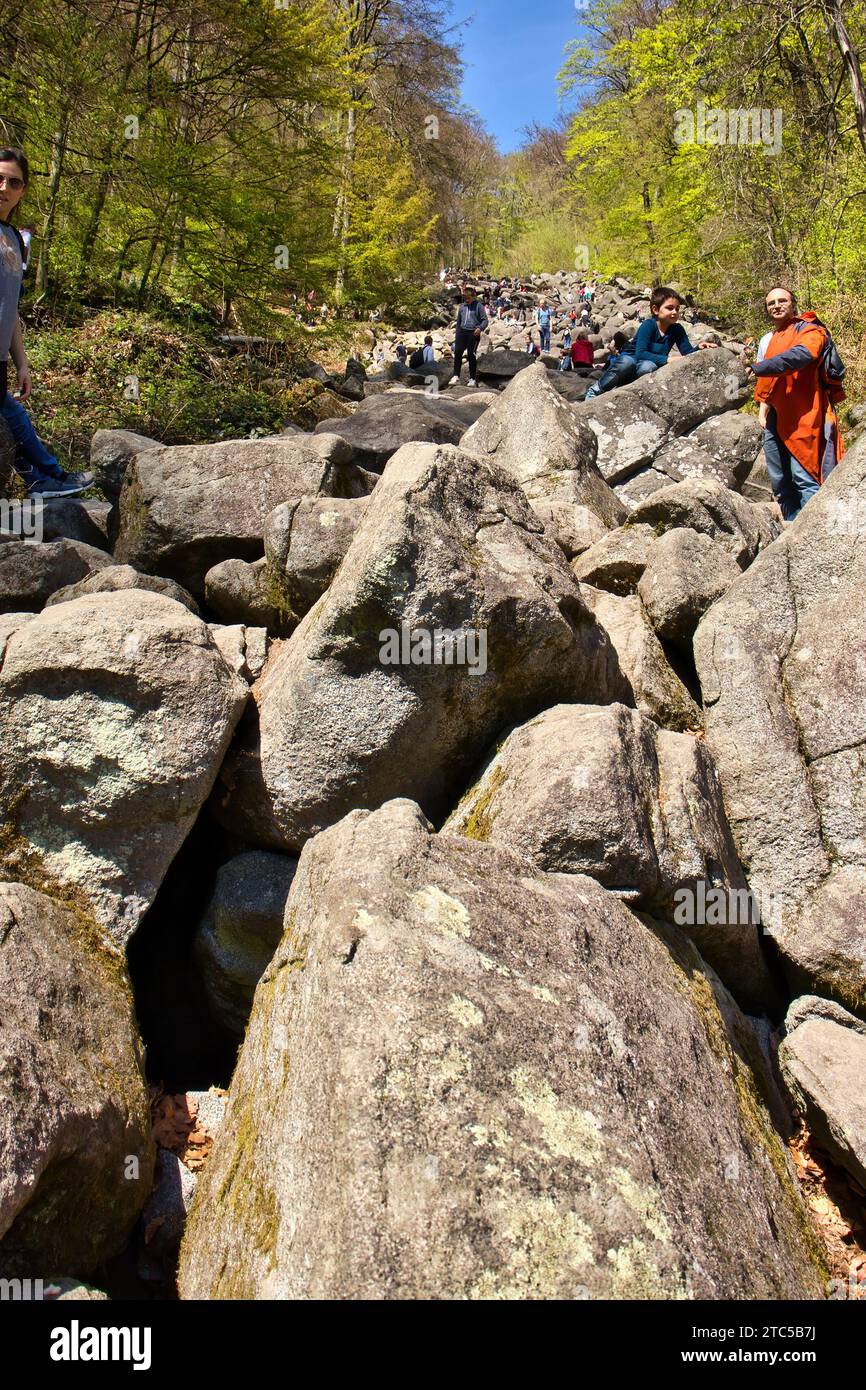 Lautertal, Germany - April 24, 2021: Large rocks and boulders on a hill in the forest at Felsenmeer on a spring day in Germany. Stock Photo