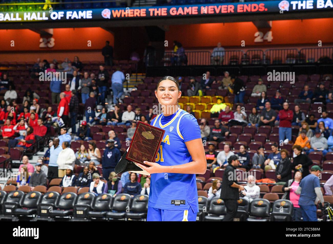 Uncasville, CT, USA. 10th Dec, 2023. UCLA Bruins center Lauren Betts (51) poses for a photo with the Most Valuable Player award for the NCAA women's basketball game in the Invesco QQQ Basketball Hall of Fame Women's Showcase between the Florida State Seminoles and the UCLA Bruins at Mohegan Sun Arena in Uncasville, CT. Erica Denhoff/CSM (Credit Image: © Erica Denhoff/Cal Sport Media). Credit: csm/Alamy Live News Stock Photo