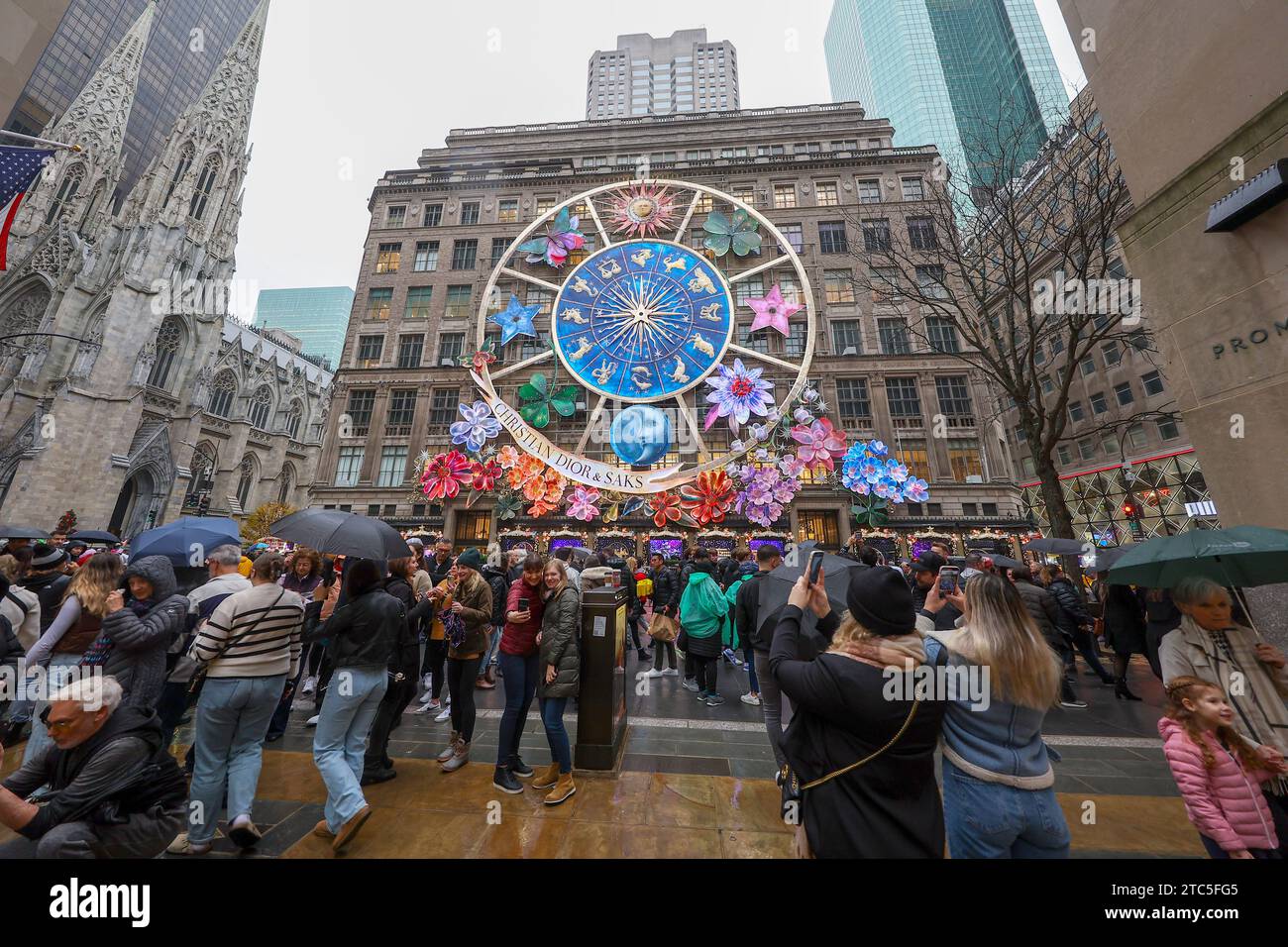 New York City, United States. 10th Dec, 2023. People are taking photos with mobile devices outside, across the street from Saks Fifth Avenue in New York, New York, on December 10, 2023. (Photo by Gordon Donovan/NurPhoto) Credit: NurPhoto SRL/Alamy Live News Stock Photo