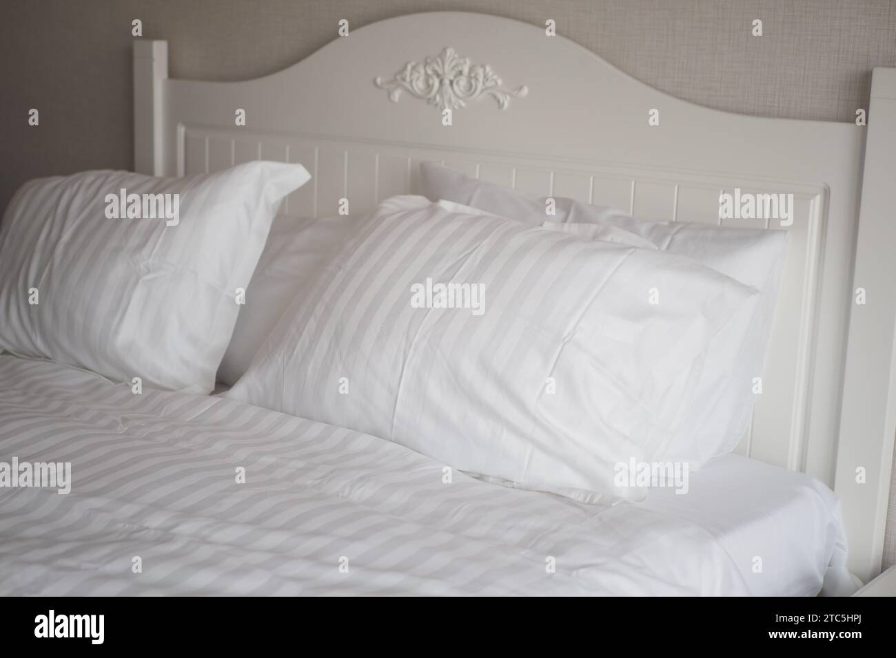 white pillow lined up on bed  Stock Photo