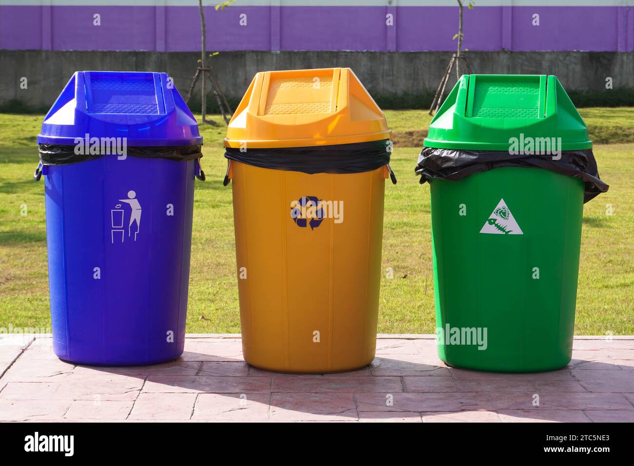 Set of plastic bins, green, yellow and blue. Different colored trash