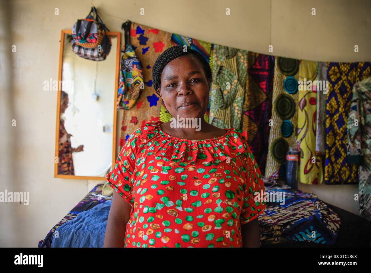 Beatrice Anyango a tailor at Afrowema poses for a photo at her