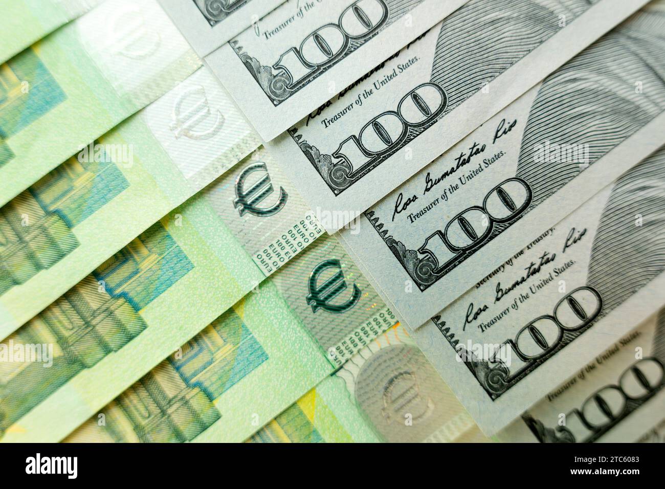 Close-up image of hundred dollar and hundred euro bills. Banknotes of 100 US dollars and 100 euros. Currency exchange rate. Stock Photo