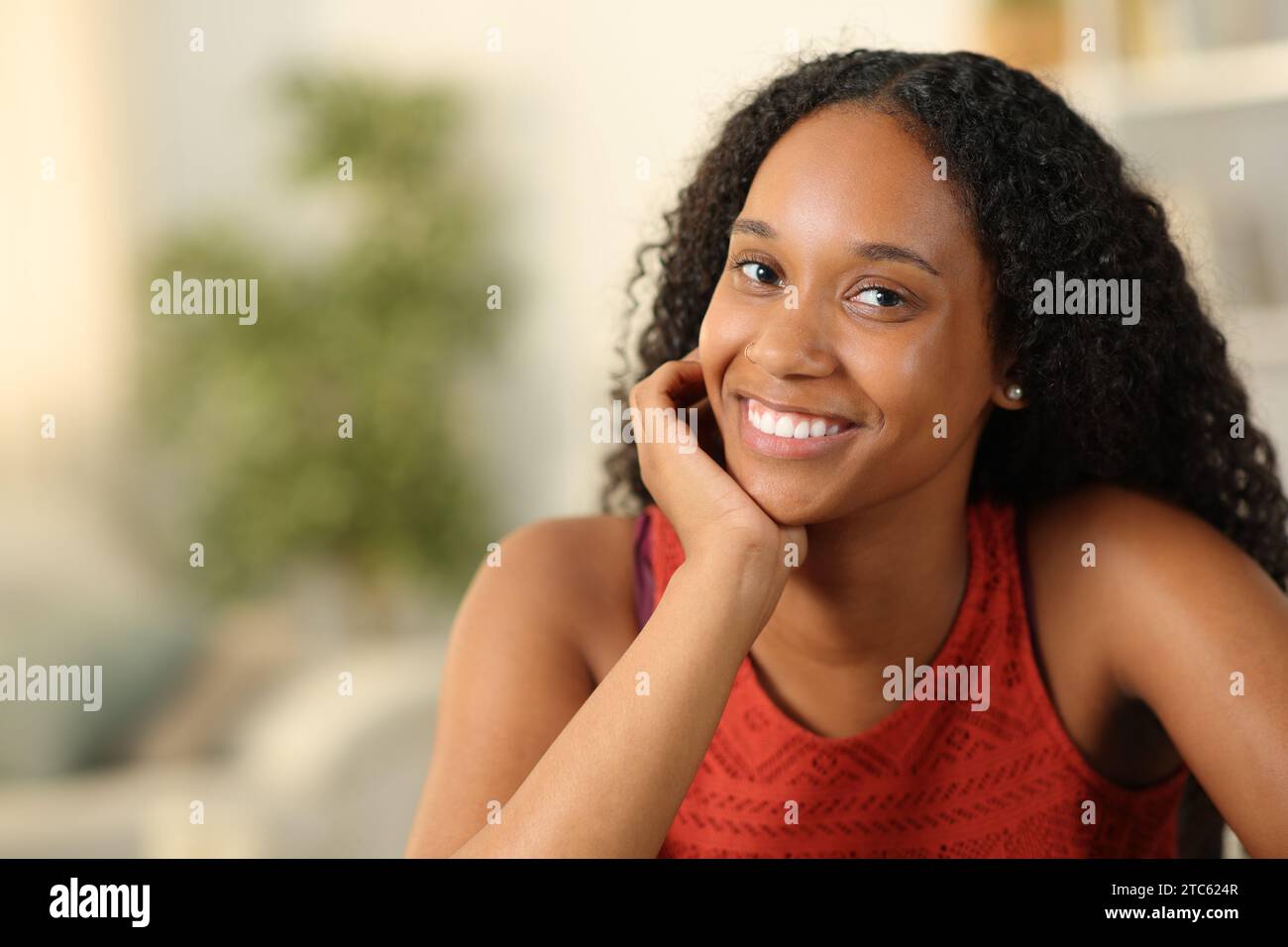 Beautiful black woman smiling at camera posing at home Stock Photo