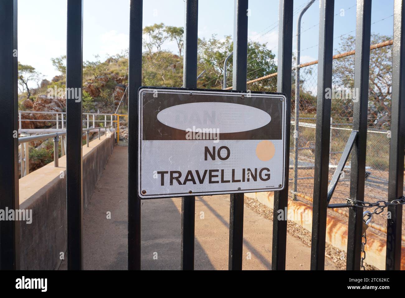 Danger No Travelling sign on fence at Lake Moondarra Dam, Mt Isa, Queensland, Australia, Stock Photo