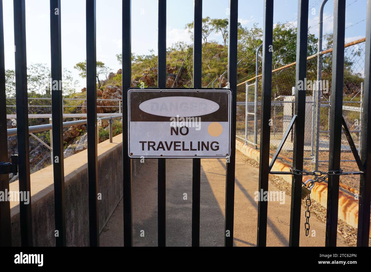 Danger No Travelling sign on fence at Lake Moondarra Dam, Mt Isa, Queensland, Australia, Stock Photo