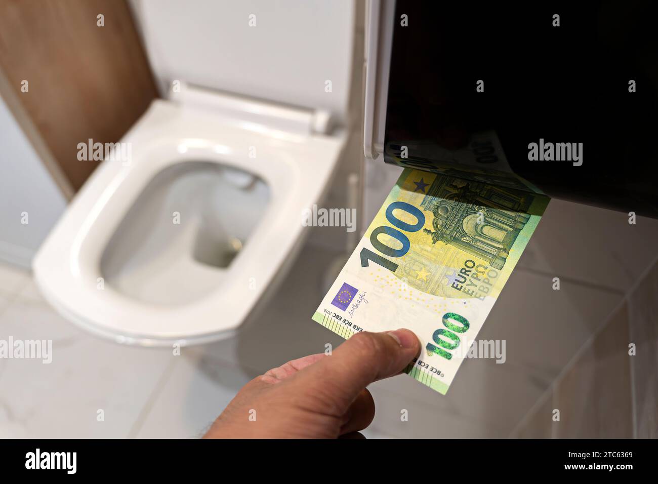 concept of senseless waste of money, loss, useless waste, large water costs, waste of money concept with euro bill and toilet. loss of money, losing m Stock Photo