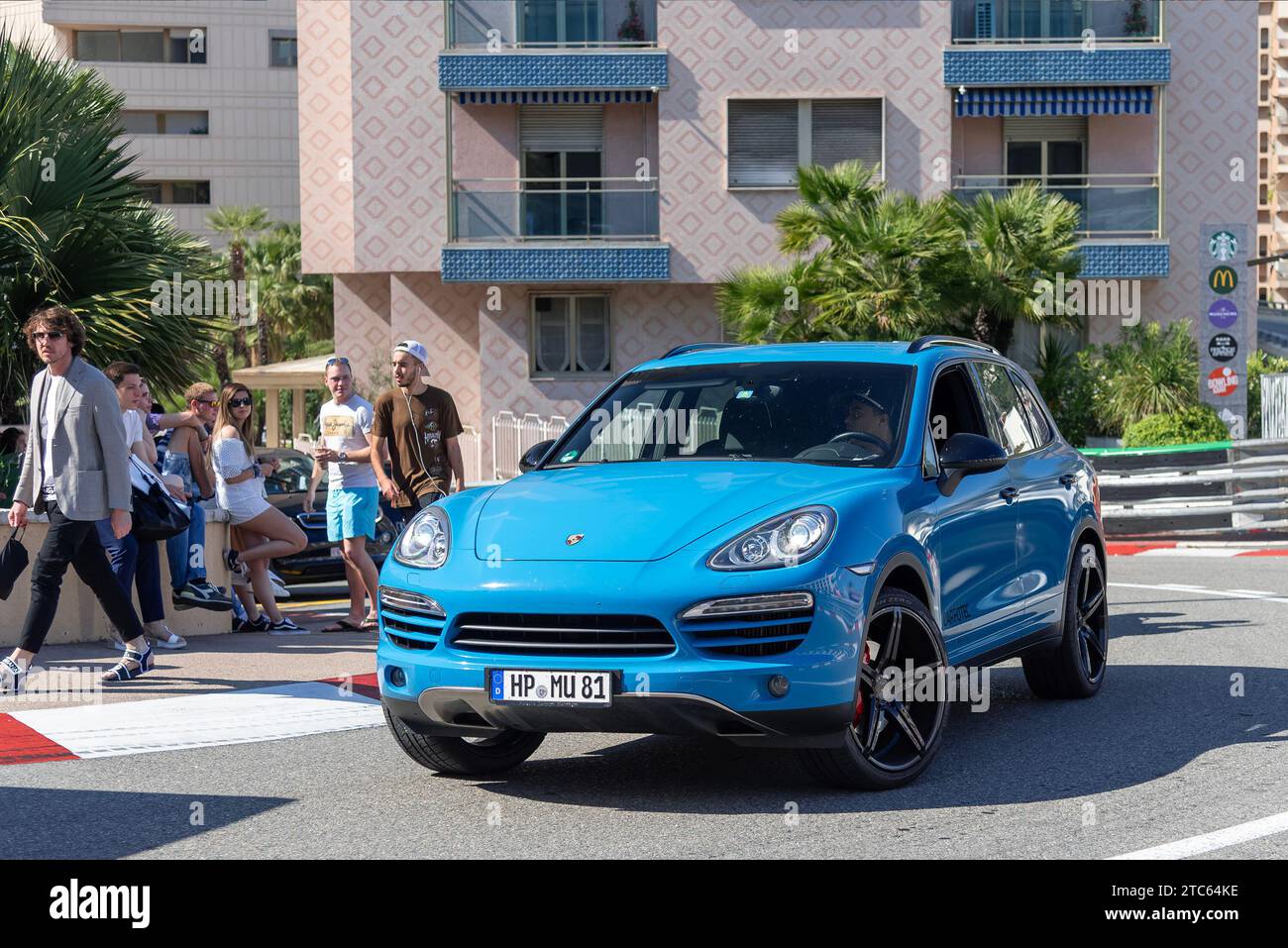 Monaco, Monaco - Blue Porsche Cayenne driving on the road in the