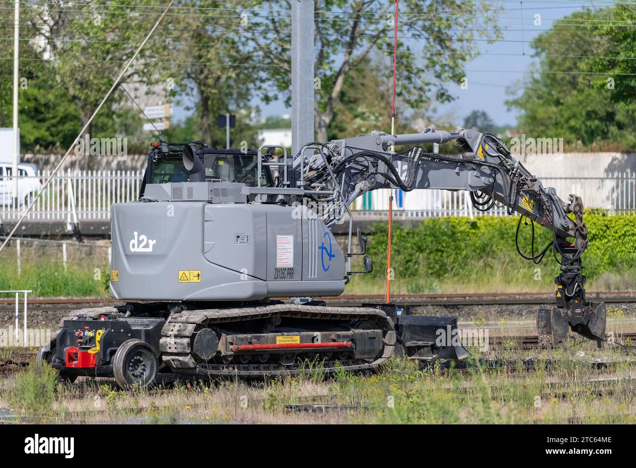 Nancy, France - Grey road-rail crawler excavator D2R ZX135C PRR at the railway depot at Nancy station. Stock Photo