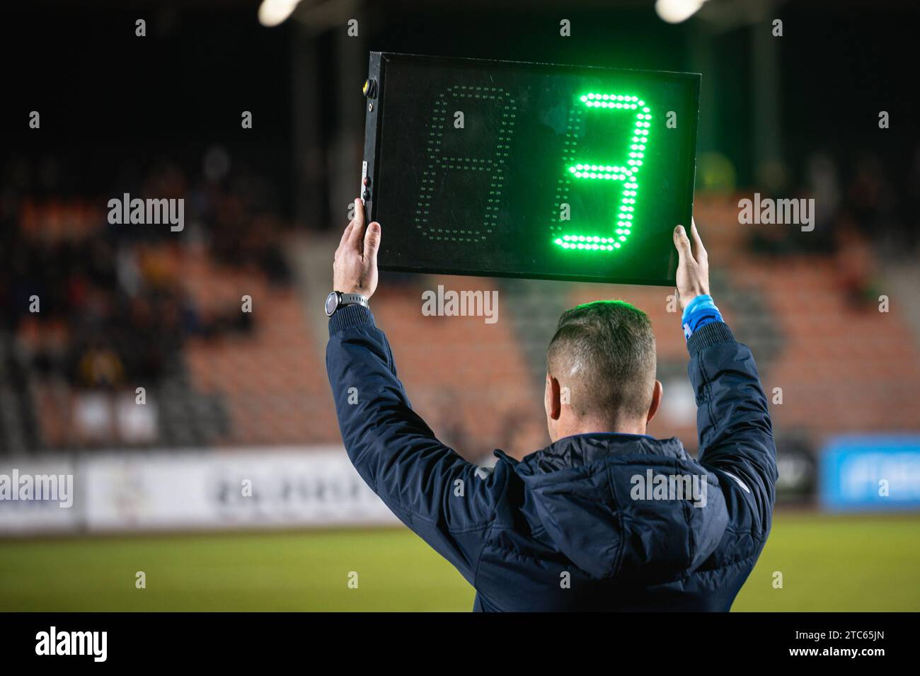 Technical referee shows added time during football match Stock Photo