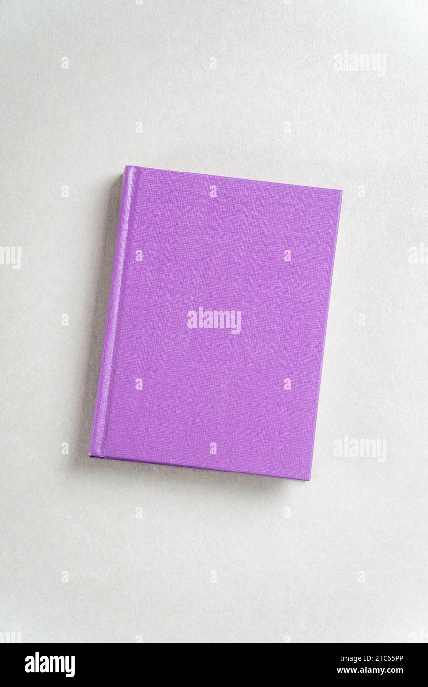 Purple closed notebook on gray background. View from above Stock Photo