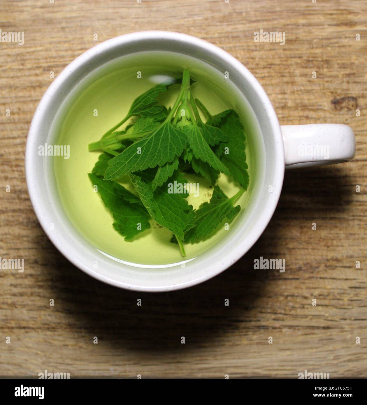 Tea Cup With Freshly Brewed Herbal Tea On Wooden Board Closeup Stock Photo Stock Photo