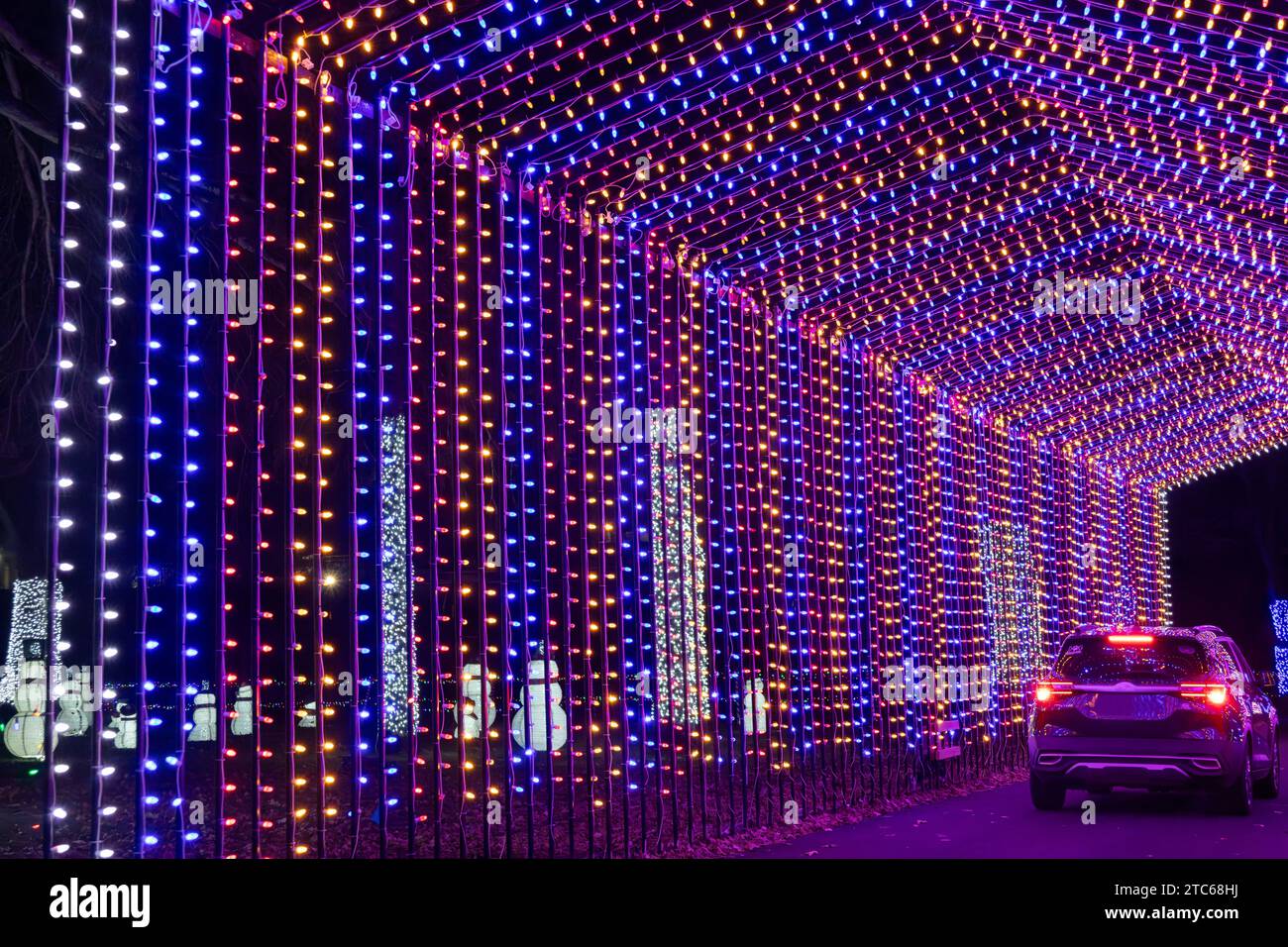 Texture background view of colorful holiday lights depicting a covered bridge with an automobile Stock Photo