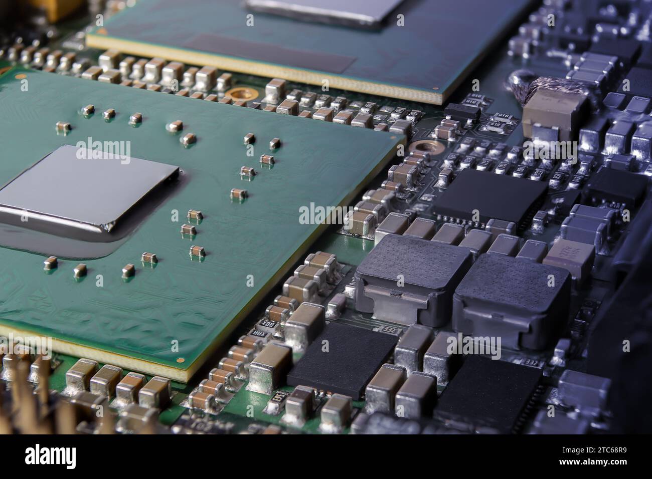Modern electronic circuit board with processor, integrated circuits and surface mounted passive components close up. Technology background Stock Photo