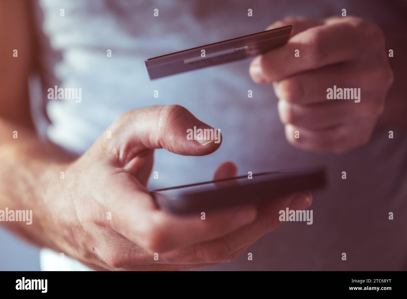 Credit card and mobile phone app online purchase, closeup of male hands using smartphone to complete financial transaction on internet Stock Photo