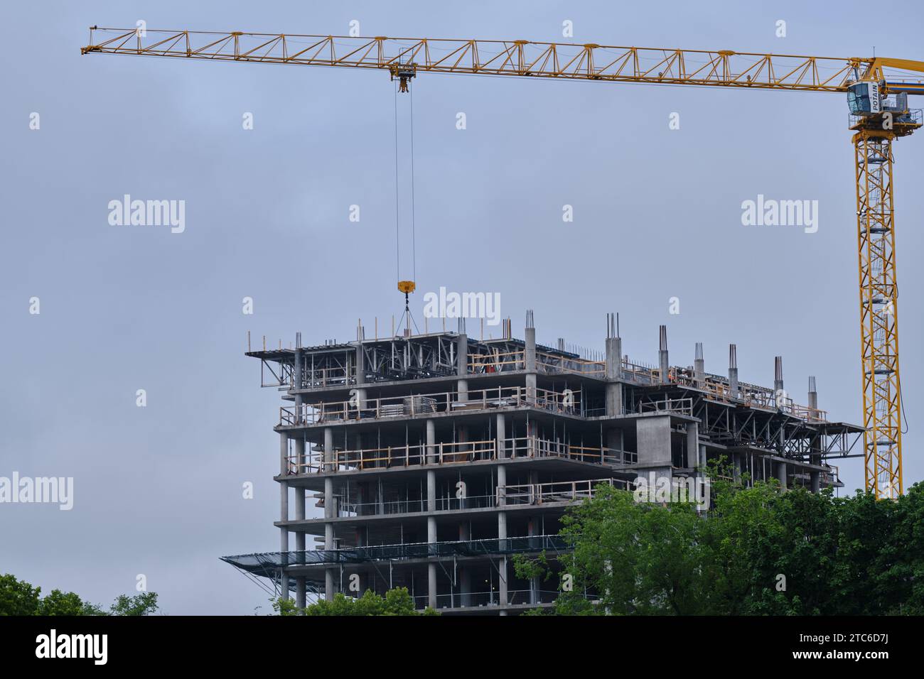 Construction Crane on multi story apartment building construction site Stock Photo