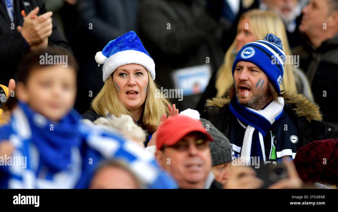 Brighton fans in Santa hats during the Premier League match between Brighton and Hove Albion and Burnley at the American Express Stadium  , Brighton , UK - 9th December 2023 Photo Simon Dack / Telephoto Images Editorial use only. No merchandising. For Football images FA and Premier League restrictions apply inc. no internet/mobile usage without FAPL license - for details contact Football Dataco Stock Photo