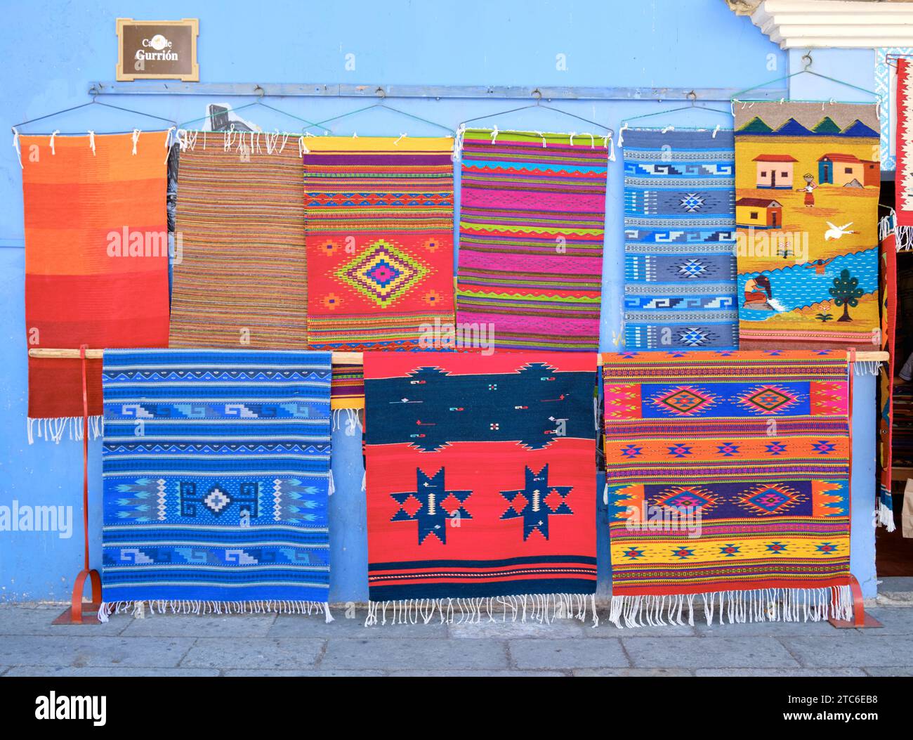 Traditional woven Mexican rugs hanging on wall outside a shop in Oaxaca