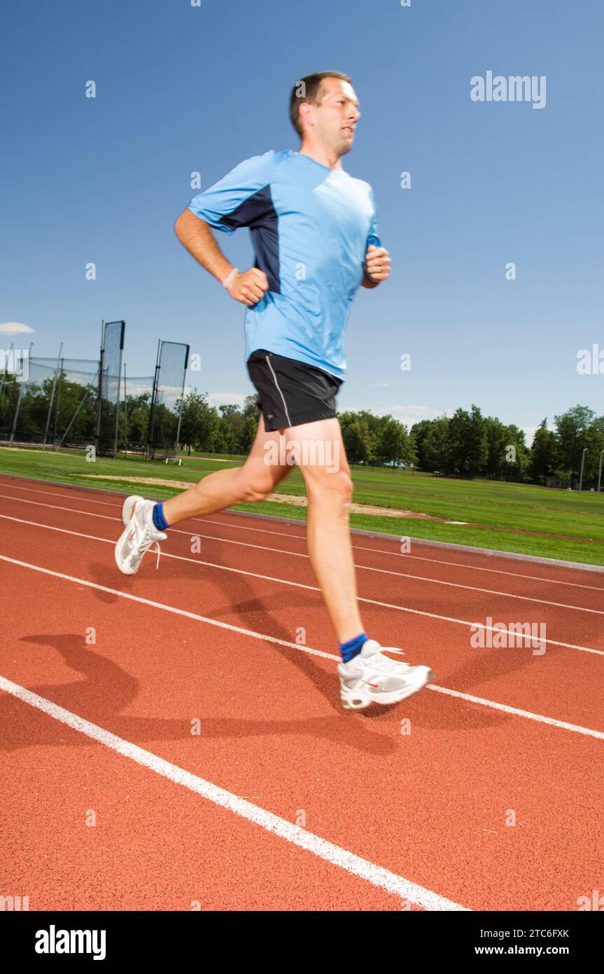 A man running on a track on June 20, 2007 in Fort Collins, Colorado. Stock Photo