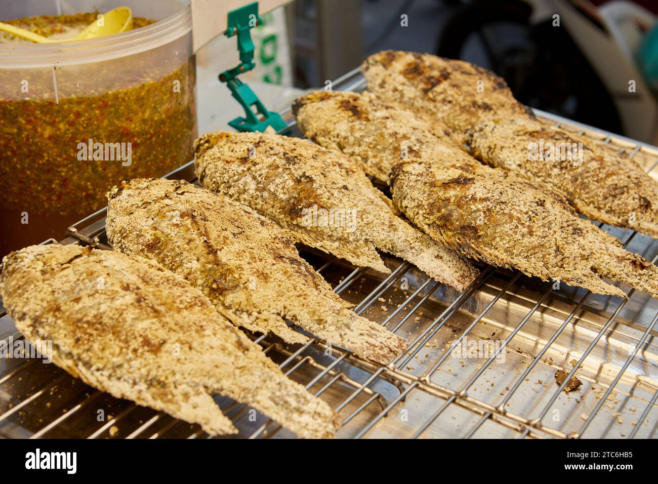 Salt crusted grilled tilapia fish for sale at market stall Stock Photo