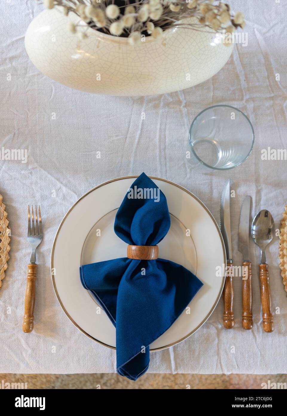 Festive white and royal blue table setting with wooden accents Stock
