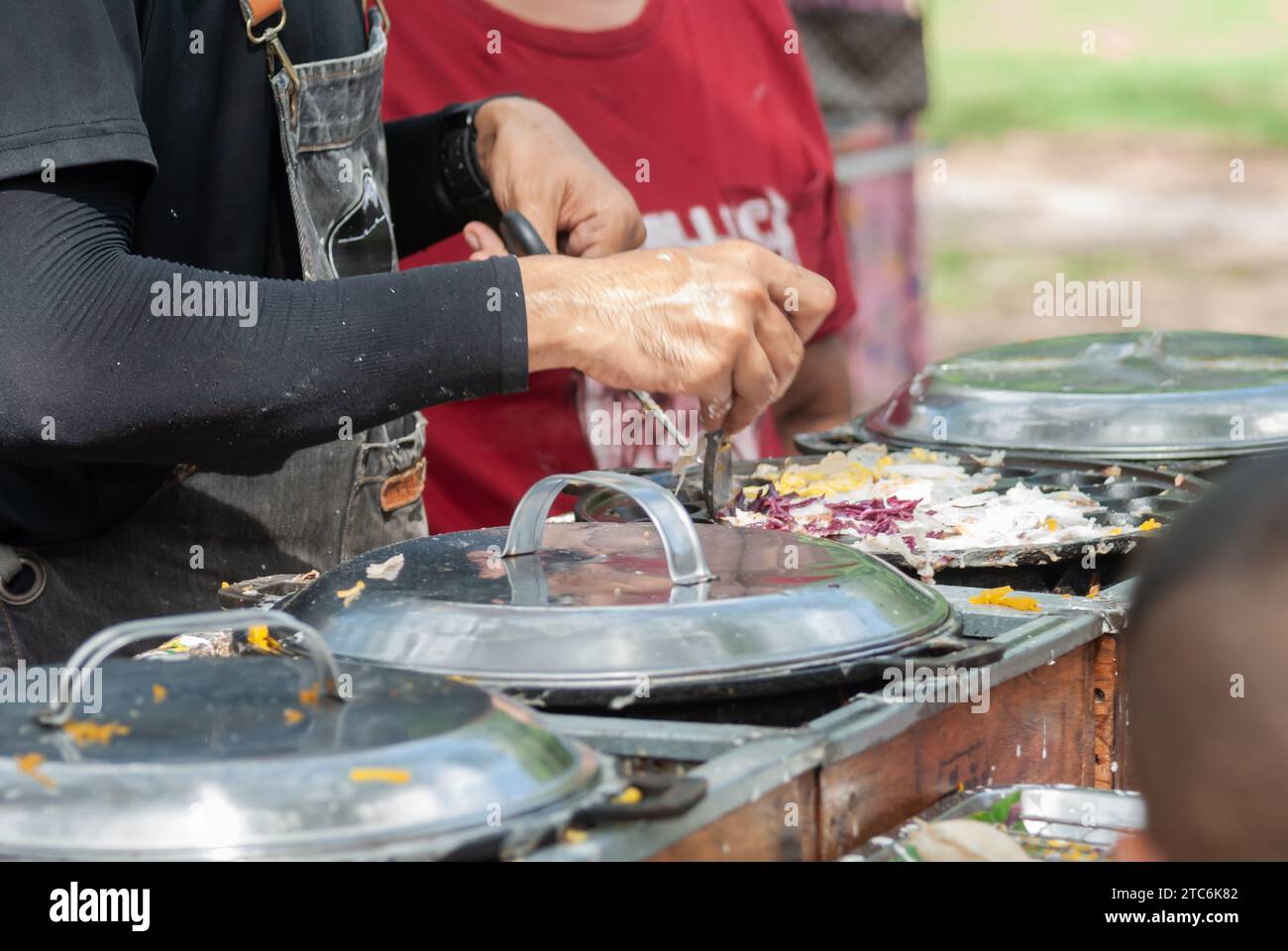 Thai Pancake, Male hands making khanom krok Traditional Thai desserts with delicious flavors are popular among Thai people and tourists around the wor Stock Photo