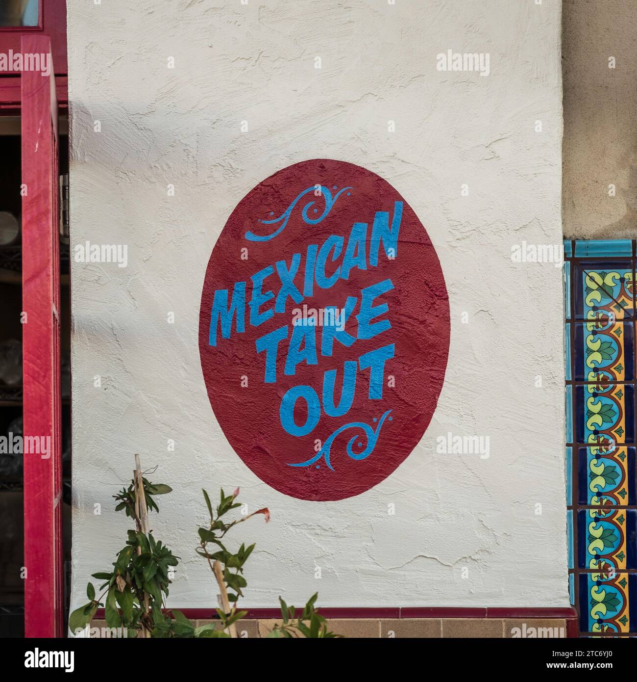 Mexican Take Out sign, painted onto a wall, outside a restaurant, in San Diego, California Stock Photo