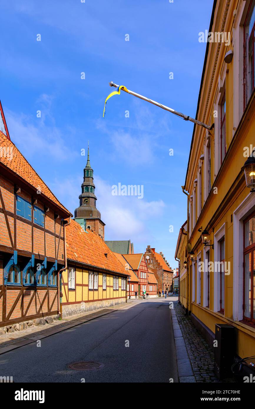 Picturesque alleyway and old town backdrop with a view of St Mary's Church in Ystad, Skåne, Skane län, Sweden. Stock Photo