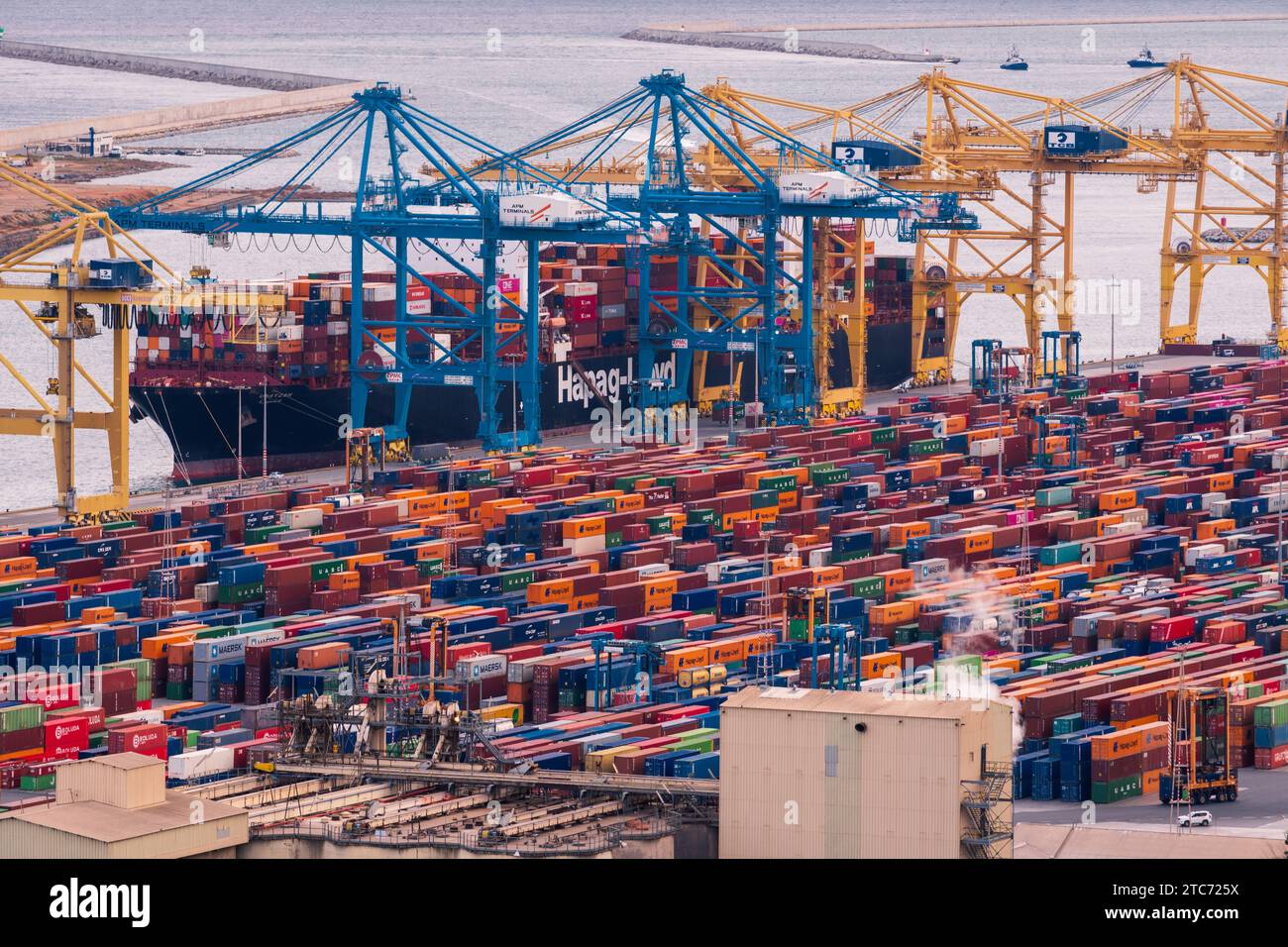 Cargo Ship and Containers in the Bustling Port of Barcelona, Spain, November 10th 2023 Stock