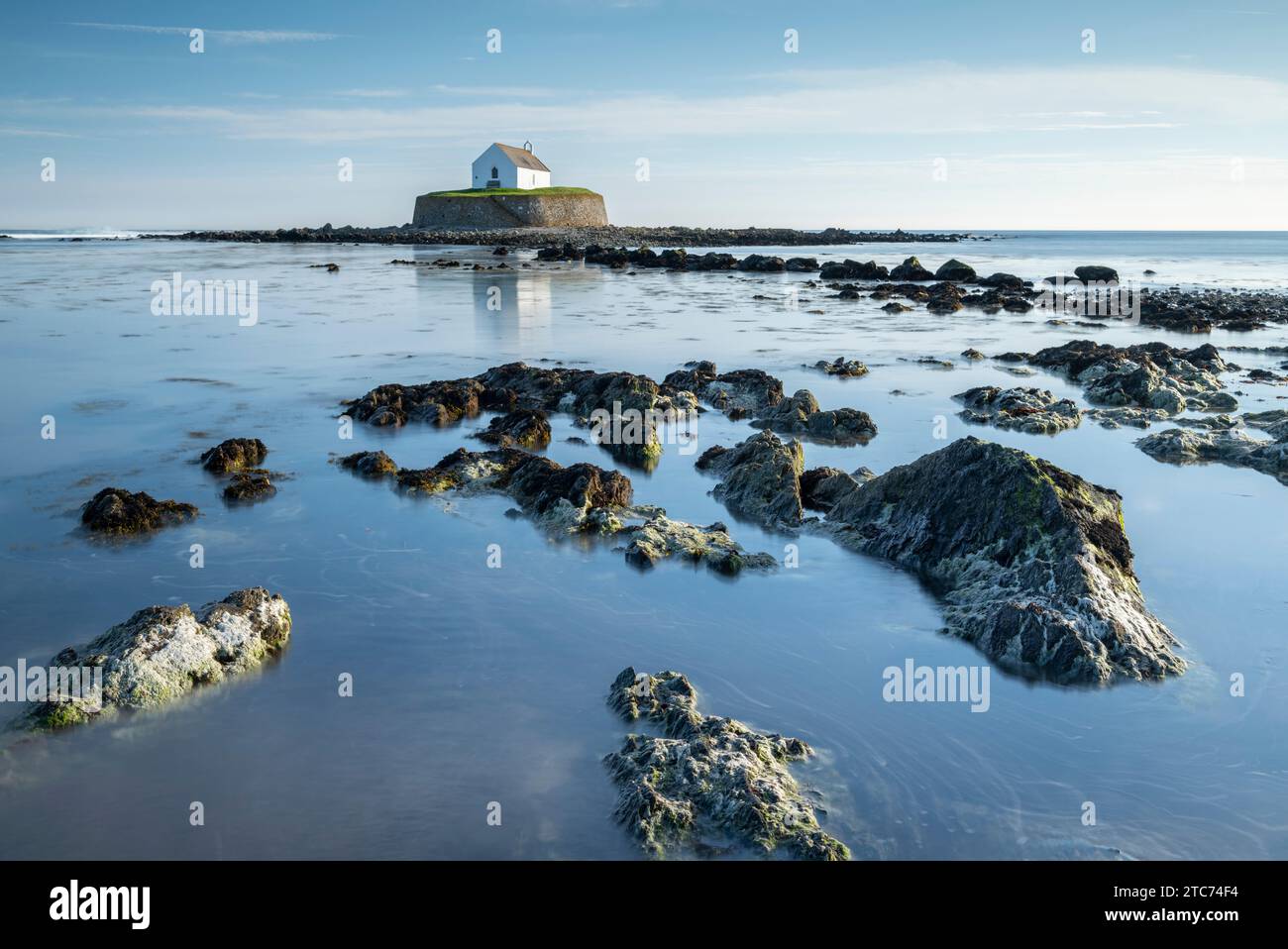 St Cwyfan's Church on a tidal islet in St Cwyfan's Bay, Anglesey, Wales, UK.  Spring (May) 2019. Stock Photo