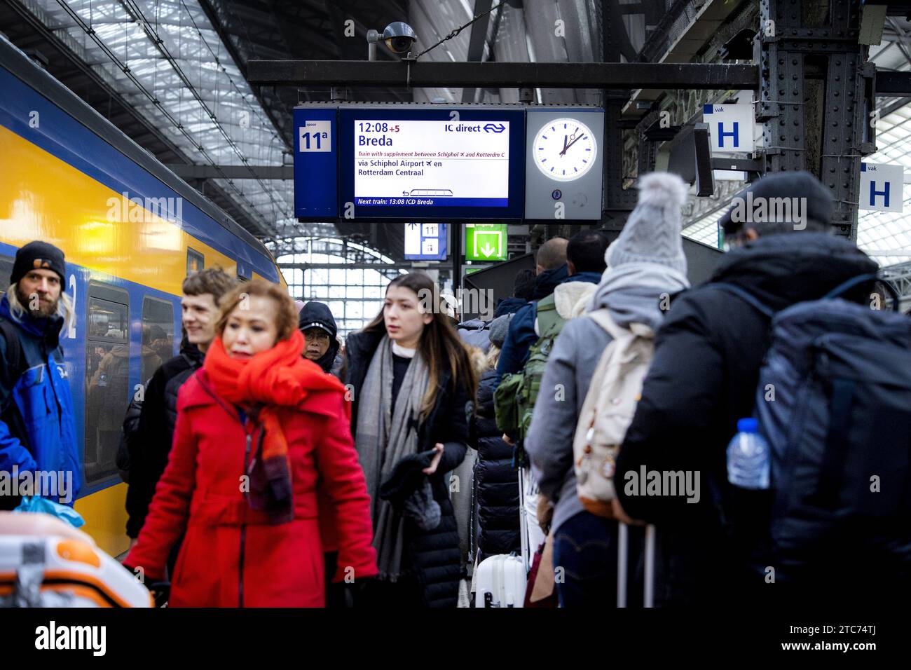 AMSTERDAM - Travelers at Amsterdam Central station. The new NS timetable has come into effect. For example, more intercity trains run between the major cities and the Intercity Direct between Amsterdam and Breda runs all day long. ANP RAMON VAN FLYMEN netherlands out - belgium out Stock Photo